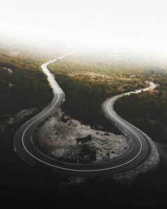 A winding, green road symbolizing the continuous Type 1 Diabetes journey 2025 and its ups and downs.