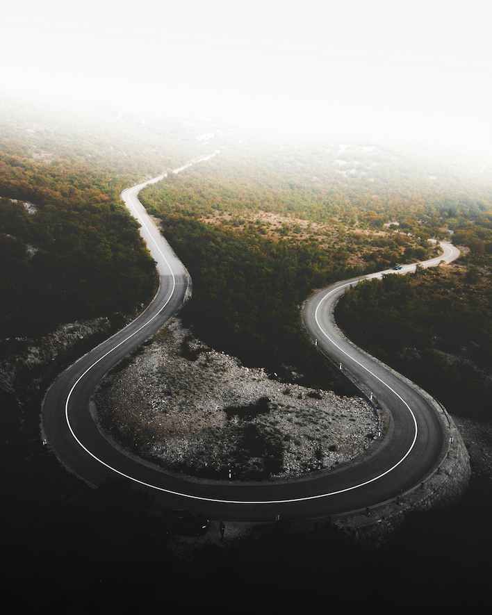 A winding, green road symbolizing the continuous Type 1 Diabetes journey 2025 and its ups and downs.