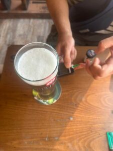 A person with Type 1 Diabetes responsibly checking their CGM while managing alcohol.