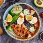 A colorful T1D-friendly recipe: a power bowl with grilled chicken, quinoa, avocado, and mixed greens.