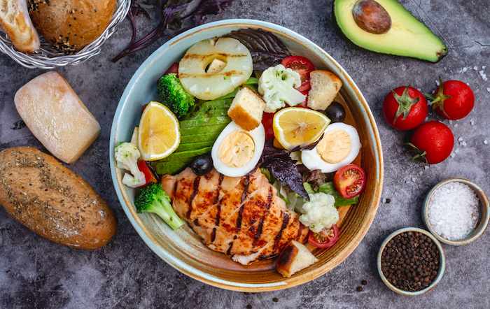 A colorful T1D-friendly recipe: a power bowl with grilled chicken, quinoa, avocado, and mixed greens.