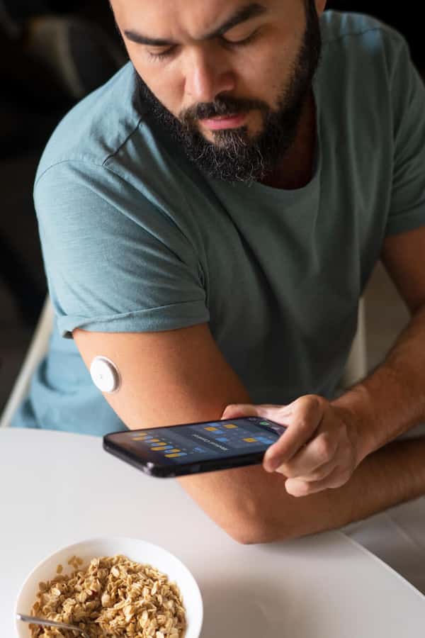 A person with Type 1 Diabetes using their CGM to help regain hypoglycemia awareness.