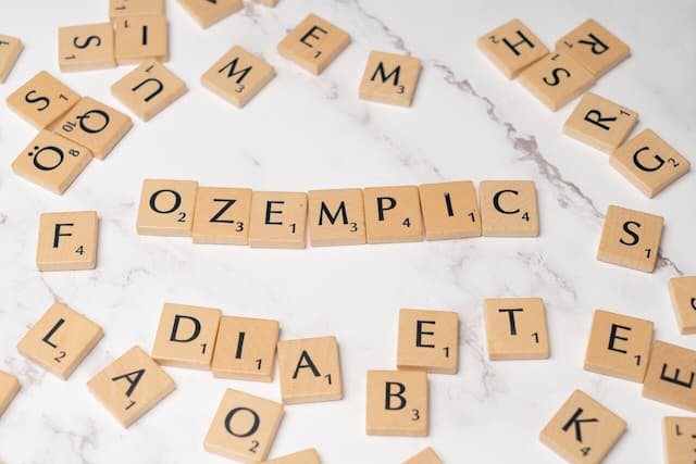 Scrabble tiles spelling out "Ozempic," symbolizing the puzzle of understanding the use of Ozempic and Type 1 Diabetes.