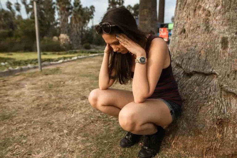 A person experiencing diabetes burnout while looking at their glucose monitoring device.
